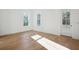 Bright bedroom featuring hardwood floors, white walls, and a glass paneled door to the patio at 9009 Stern Aly, Johns Island, SC 29455