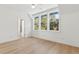 Light-filled bedroom has wood floors, three windows, and an adjacent bathroom at 9009 Stern Aly, Johns Island, SC 29455