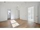Bright bedroom featuring hardwood floors, white walls, and an adjacent bathroom at 9009 Stern Aly, Johns Island, SC 29455