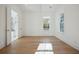 Bright bedroom featuring hardwood floors, white walls, and an adjacent bathroom at 9009 Stern Aly, Johns Island, SC 29455