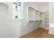 A well-organized walk-in closet with built-in shelving and wooden rods for ample storage at 9009 Stern Aly, Johns Island, SC 29455
