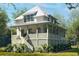 Two-story home with metal roof, porch, and landscaped yard at 9009 Stern Aly, Johns Island, SC 29455