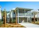 Charming exterior view of coastal home with palm trees at 9009 Stern Aly, Johns Island, SC 29455
