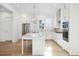 Kitchen boasts white cabinets, stainless appliances, and a large island with seating, perfect for entertaining at 9009 Stern Aly, Johns Island, SC 29455
