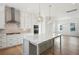 Spacious kitchen with white cabinets, stainless steel appliances, and a view to the living room at 9009 Stern Aly, Johns Island, SC 29455