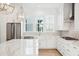 Well-lit kitchen with marble countertops, stainless steel appliances, and bright white cabinets at 9009 Stern Aly, Johns Island, SC 29455