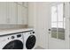Laundry room with modern washer and dryer, gray cabinets, and light countertops at 9009 Stern Aly, Johns Island, SC 29455