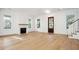 Bright living room featuring a fireplace, hardwood floors, large windows, and a modern design at 9009 Stern Aly, Johns Island, SC 29455
