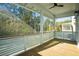 Screened porch with ceiling fan, wood floors, and a beautiful view of the surrounding trees at 9009 Stern Aly, Johns Island, SC 29455
