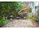 Brick patio with seating area, umbrella, grill, and lush landscaping at 11 Perry St, Charleston, SC 29403