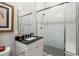 Bathroom with white vanity, walk-in shower, and patterned tile at 11 Perry St, Charleston, SC 29403