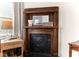 Ornate wooden fireplace mantel in charming bedroom at 11 Perry St, Charleston, SC 29403