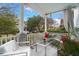 Relaxing front porch with seating area, potted plants, and a view of the street at 11 Perry St, Charleston, SC 29403