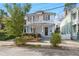 Light blue two-story house with a front porch, landscaping, and driveway at 11 Perry St, Charleston, SC 29403