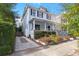 Charming light blue two-story house with a front porch and landscaped yard at 11 Perry St, Charleston, SC 29403