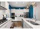 Bright kitchen boasts white cabinets, stainless steel appliances, and marble countertops at 11 Perry St, Charleston, SC 29403