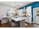 Modern kitchen featuring white cabinets, marble island, and a stainless steel range hood at 11 Perry St, Charleston, SC 29403