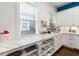 White kitchen cabinets and marble countertops with built-in shelving at 11 Perry St, Charleston, SC 29403