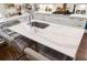 Kitchen island with white marble countertop and seating for two at 11 Perry St, Charleston, SC 29403