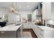 L-shaped kitchen with white cabinets, marble countertops, and gold lighting at 11 Perry St, Charleston, SC 29403