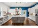 Stylish kitchen featuring white cabinets, a large island, and blue accent wall at 11 Perry St, Charleston, SC 29403