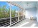Relaxing screened porch with rocking chair and ceiling fan at 11 Perry St, Charleston, SC 29403
