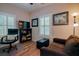 Home office with hardwood floors, comfortable seating, and a large TV at 1374 Leisure Dr, Summerville, SC 29486
