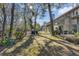 Sunny backyard with lush greenery and large trees providing shade at 14 Wappoo Creek Pl, Charleston, SC 29412