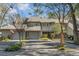 Two-story home with gray siding, double garage, and mature trees at 14 Wappoo Creek Pl, Charleston, SC 29412