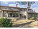 Two-story home with sunroom, gray siding and mature landscaping at 14 Wappoo Creek Pl, Charleston, SC 29412