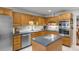 Modern kitchen with oak cabinets, stainless steel appliances, and an island at 14 Wappoo Creek Pl, Charleston, SC 29412
