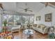 Sunroom features hardwood floors, comfortable seating, and large windows at 14 Wappoo Creek Pl, Charleston, SC 29412