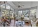 Bright sunroom with hardwood floors, wicker furniture, and scenic backyard views at 14 Wappoo Creek Pl, Charleston, SC 29412