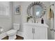 Modern bathroom with white vanity, large mirror, and dark wood floors at 1615 Paradise Lake Dr, Mount Pleasant, SC 29464