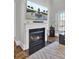 Modern fireplace with a large TV above and a black granite hearth at 1615 Paradise Lake Dr, Mount Pleasant, SC 29464