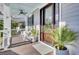 Front porch with rocking chairs and a wooden door at 1615 Paradise Lake Dr, Mount Pleasant, SC 29464