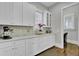 White kitchen cabinets, quartz countertops, and built-in workspace at 1615 Paradise Lake Dr, Mount Pleasant, SC 29464