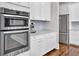 Stainless steel appliances and white cabinets highlight this kitchen at 1615 Paradise Lake Dr, Mount Pleasant, SC 29464