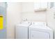 Bright laundry room with washer, dryer, and overhead shelving at 2333 Chatelain Way, Mount Pleasant, SC 29464