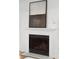 Simple white fireplace with modern artwork above at 265 Alexandra Dr # 10, Mount Pleasant, SC 29464