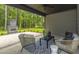 Relaxing covered patio with outdoor fireplace and seating area at 270 Darby Meadow Ln, Ridgeville, SC 29472