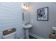 Small bathroom with pedestal sink and shiplap accent wall at 270 Darby Meadow Ln, Ridgeville, SC 29472