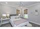 Cozy bedroom with a queen bed, window seat, and soft color palette at 270 Darby Meadow Ln, Ridgeville, SC 29472