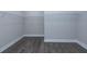 Large walk-in closet with double hanging rods and wood-look flooring at 270 Darby Meadow Ln, Ridgeville, SC 29472