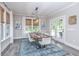 Bright dining room features a rustic wood table, white chairs, and access to a backyard patio at 270 Darby Meadow Ln, Ridgeville, SC 29472