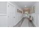 Bright entryway with white wainscoting, wood-look tile flooring, and a bench at 270 Darby Meadow Ln, Ridgeville, SC 29472