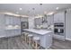 Modern kitchen with gray cabinets, quartz countertops, and stainless steel appliances at 270 Darby Meadow Ln, Ridgeville, SC 29472