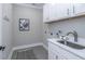 Bright laundry room with white cabinets and a utility sink at 270 Darby Meadow Ln, Ridgeville, SC 29472
