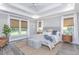 Spacious main bedroom with a king-size bed, coffered ceiling, and plenty of natural light at 270 Darby Meadow Ln, Ridgeville, SC 29472