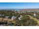 Aerial view showcasing a two-story home near a golf course and waterfront at 279 Driftwood Ln, Edisto Beach, SC 29438
